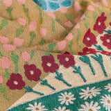 Colorful woven throw blanket with a floral pattern and geometric designs