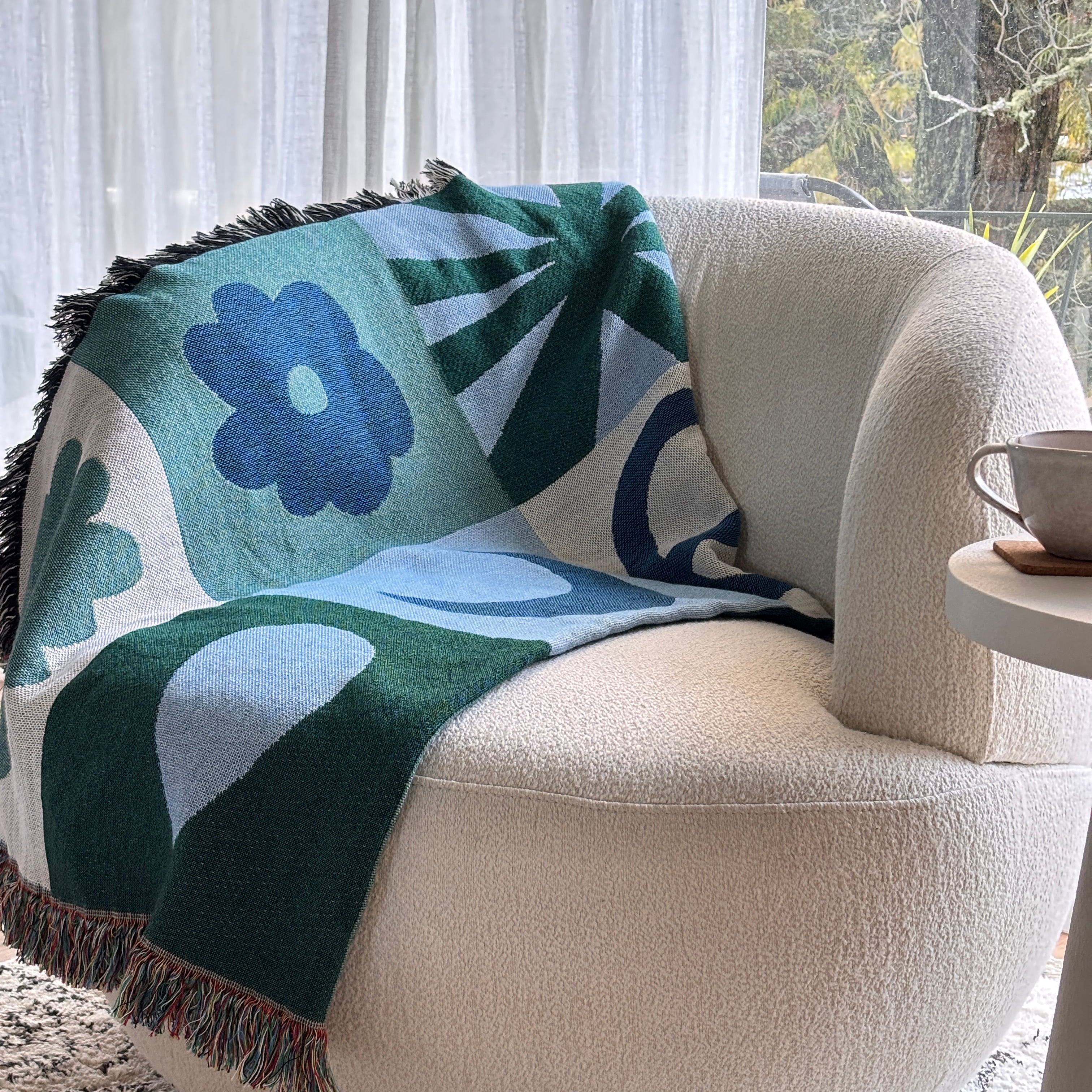 Geometric throw blanket with abstract patterns draped over a chair