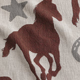 Woven blanket close-up with brown horse and star patterns
